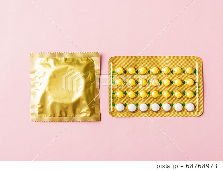 Condom in wrapper pack and contraceptive pills 68768973