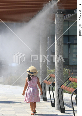ドライミストを浴びる人　猛暑日　熱中症予防　熱中症対策　少女　一人 68770113