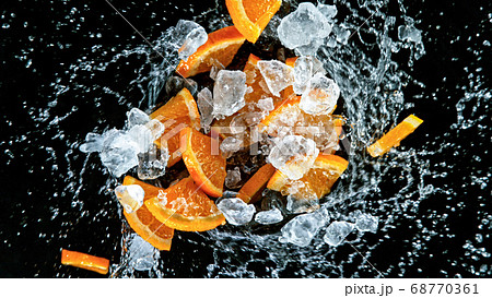 Fresh ripe oranges flying on a black background. 68770361