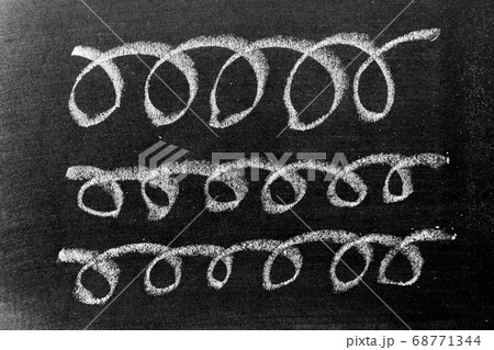 White color chalk hand drawing in set of curve or wavy line shape on black board background 68771344