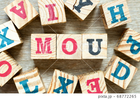 Alphabet letter block in word MOU (Abbreviation of memorandum of understanding) with another on wood background Alphabet letter block in word MOU (Abbreviation of memorandum of understanding) with another on wood background 68772265