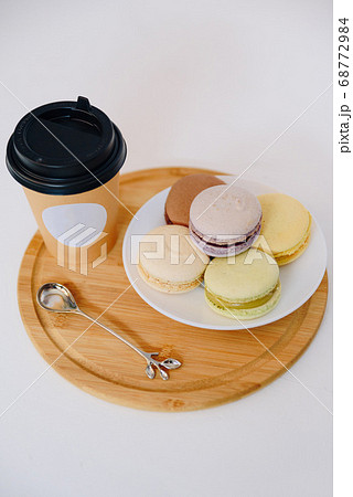 Several colorful macaroon cakes on a colored 68772984