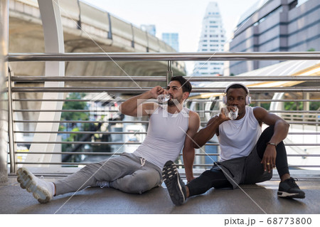 American friends sit and drink water after American friends sit and drink water after 68773800