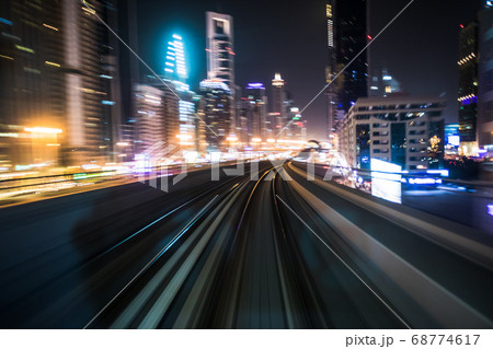 Tran running on rails in a night city. 68774617
