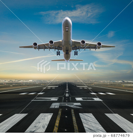 Airplane taking off from the airport runway 68774679