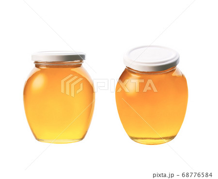 glass jar of honey isolated on white background. glass jar of honey isolated on white background. 68776584