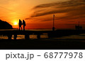 桟橋で夕陽を眺めるカップル 68777978