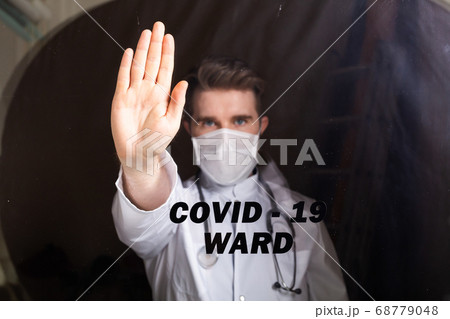 Doctor man using mask with open hand doing stop sign with serious and confident expression, defense gesture. Coronavirus outbreak, covid-19 and pandemic concept. Isolation ward. 68779048