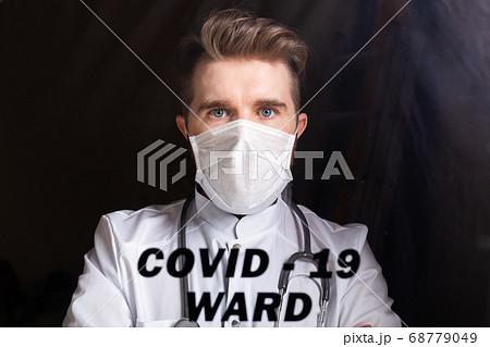 Medicine and health care concept. Man doctor in hospital. Doctor wearing protective mask checking and take care infected people from covid-19. 68779049