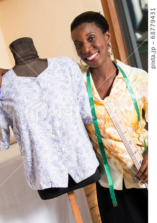 Young seamstress and her mannequin. 68779431
