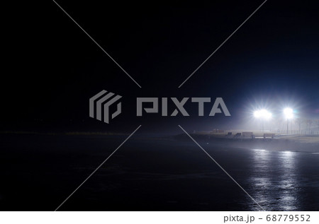Dense fog on a frozen lake at night. 68779552