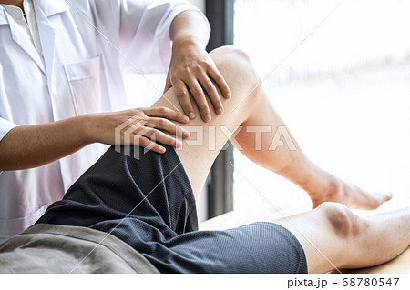 Female Physiotherapist working examining treating 68780547
