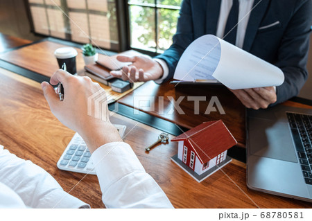 Real estate agent are presenting home loan and Real estate agent are presenting home loan and 68780581