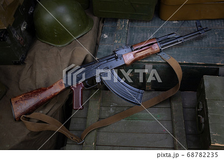 AK 47 gun with ammunitions on army box background AK 47 gun with ammunitions on army box background 68782235