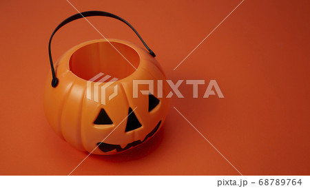Jack o lantern pumpkin on orange background Jack o lantern pumpkin on orange background 68789764