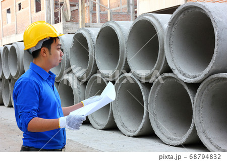 the worker is checking the stock of cement drain in construction site the worker is checking the stock of cement drain in construction site 68794832