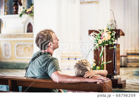 Christian dad tells his son Bible stories about Jesus sitting in kirk. Faith, religious education, modern church, father day, fatherly responsibilities, father influence on formation of son worldview 68796209