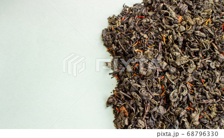 Dry green tea leaves on a light background. Empty 68796330