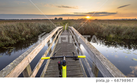 Bicycle on wooden bridge Bicycle on wooden bridge 68798967