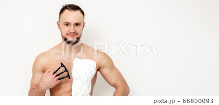 Young man shaving his chest Young man shaving his chest 68800093