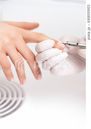 Close up of manicurist using manicure cutter 68800905