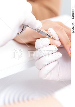 Close up of manicurist using manicure scissors 68800906