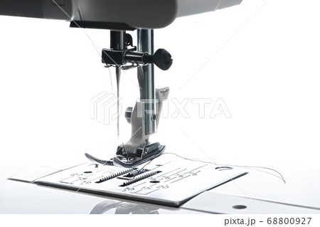8 - Medium horizontal image of sewing machine working area. Plate foot needle thread and housing above is all visible. 8 - Medium horizontal image of sewing machine working area. Plate foot needle thread and housing above is all visible. 68800927