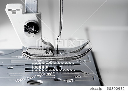 5 - Macro sewing machine side view with flat foot plate ready to stitch. 5 - Macro sewing machine side view with flat foot plate ready to stitch. 68800932