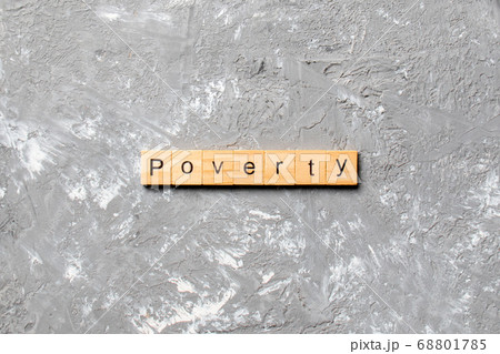 Poverty word written on wood block. Poverty text 68801785