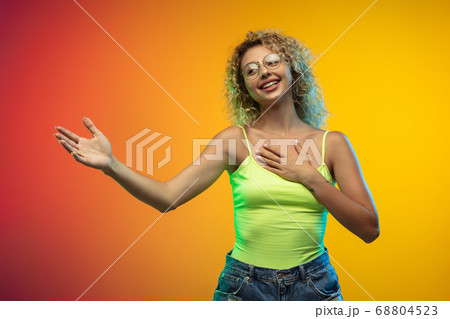 Caucasian young woman's portrait on gradient studio background in neon Caucasian young woman's portrait on gradient studio background in neon 68804523