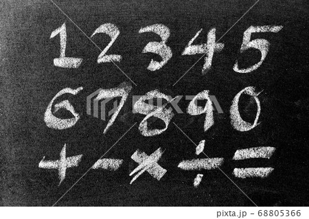 White color chalk hand drawing of number and mathematics symbol (Plus, minus multiply, divide and equal sign) on blackboard background White color chalk hand drawing of number and mathematics symbol (Plus, minus multiply, divide and equal sign) on blackboard background 68805366