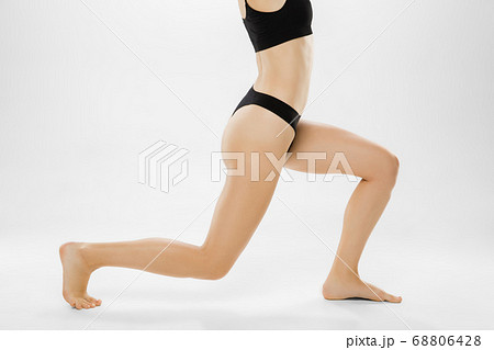 Beautiful female legs and belly isolated on white background. Beauty, cosmetics, spa, depilation, treatment and fitness concept. 68806428