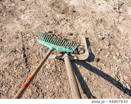 Farmer crearing big dung from a horse on ground Farmer crearing big dung from a horse on ground 68807630