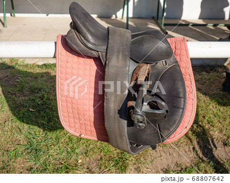 Plastic stirrups and leather strips on a dark Plastic stirrups and leather strips on a dark 68807642