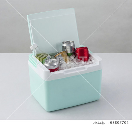 Opened green cooling box with bottles of beverage 68807702