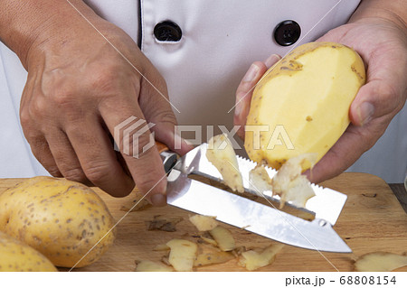 Chef peeling potato to make mashed Potatoes Chef peeling potato to make mashed Potatoes 68808154