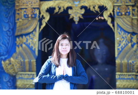 buddhist show Namaste hands in front of the blue temple 68810001