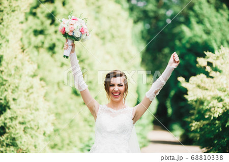 Portrait of stunning bride with long hair posing with great bouquet Portrait of stunning bride with long hair posing with great bouquet 68810338