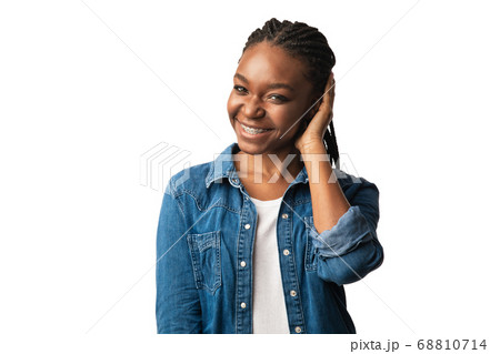 Cheerful Black Girl Holding Hand Near Ear Over White Background Cheerful Black Girl Holding Hand Near Ear Over White Background 68810714