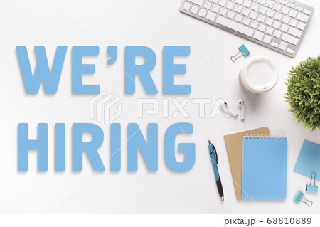Flat lay composition with keyboard and office supplies on white table, collage with phrase WE'RE HIRING 68810889