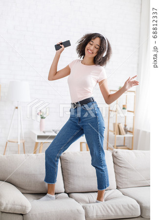 African american girl enjoying musical break at work remotely African american girl enjoying musical break at work remotely 68812337