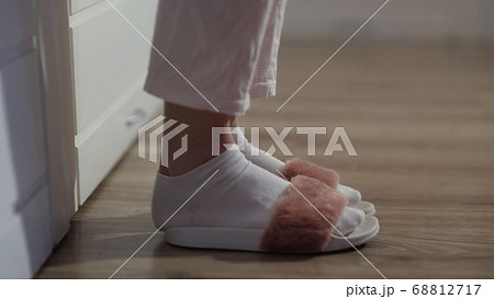Woman getting out of bed, put on slippers 68812717