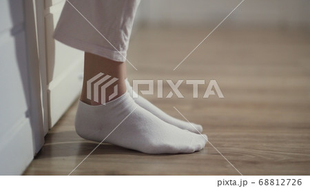 Woman is socks getting out of bed and go out 68812726