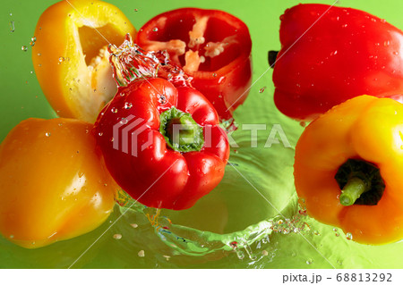 Red and yellow paprika in water splashes. 68813292