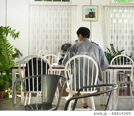 A man life in social stages; A man working in a coffee shop at social distances. 68814269