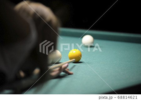 Billiard: female player getting ready to stroke a 68814621