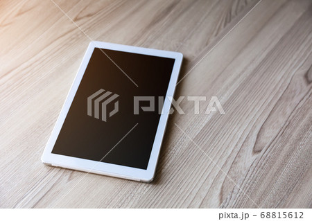 White tablet pc with empty screen on wood White tablet pc with empty screen on wood 68815612