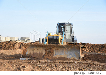 Bulldozer during of large construction jobs at building site Bulldozer during of large construction jobs at building site 68816178