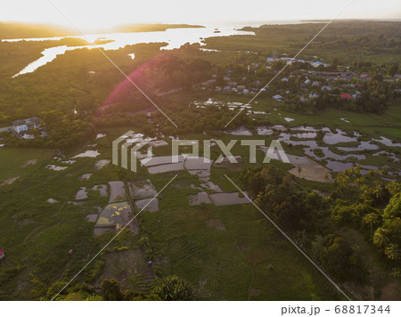 Aerial Drone shot of Chake Chake City, a Capital of Pemba island, Zanzibar archipelago. City in a river Delta at sunset time 68817344