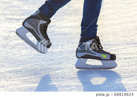 Legs of a man skating on an ice rink. Hobbies and Legs of a man skating on an ice rink. Hobbies and 68819624